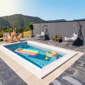a swimming pool with toys in it on a patio at Weekend house - Vlašić in Vlasic