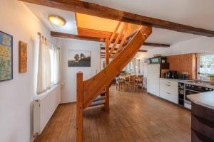 a kitchen and dining room with a staircase in a house at Ferienhaus Loppin in Jabel