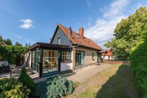 a house with a conservatory and a patio at Ferienhaus Loppin in Jabel +13 photos