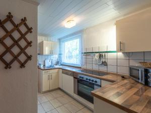 a kitchen with white appliances and a window at Luett Huus in Lärz