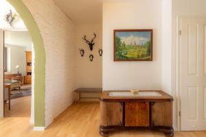 a room with a table and a painting on the wall at Die Jagdhütte in Dedelow +20 photos