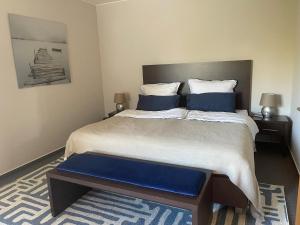 a bedroom with a large bed with blue pillows at Seeresidenz Klink in Klink