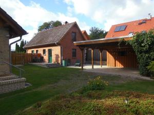 a brick house with a roof and a yard at Tannenblick Loppin DG in Jabel