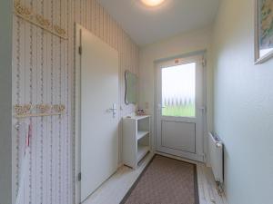 a hallway with a door and a bathroom with a window at Kornblume_DH in Röbel +17 photos