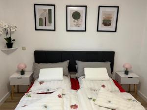 a bedroom with two beds and three pictures on the wall at WarenERleben in Waren