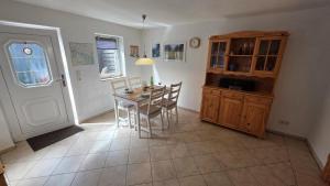 a kitchen and dining room with a table and chairs at Ferienhaus Wennmann in Waren