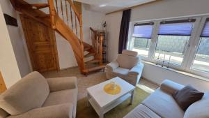 a living room with two couches and a table at Ferienhaus Wennmann in Waren