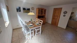 a kitchen with a table and chairs in a room at Ferienhaus Wennmann in Waren