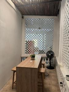 a room with a wooden table and a window at Casa 1811 in Cartagena de Indias