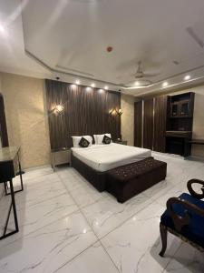 a bedroom with a large bed in a room at Palmtree Hotel in Lahore