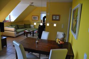 a dining room and living room with a table and chairs at Fair-Play App 04 DG R in Göhren-Lebbin