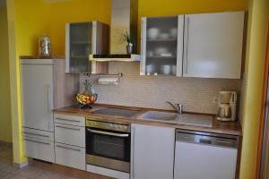 a kitchen with white cabinets and a sink at Fair-Play App 04 DG R in Göhren-Lebbin