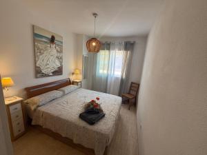 a bedroom with a bed and a painting on the wall at Magic World Frontal 1ª línea in Oropesa del Mar +22 photos