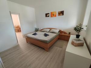 a bedroom with a bed and a table and a mirror at Za hrází Poděbrady in Poděbrady