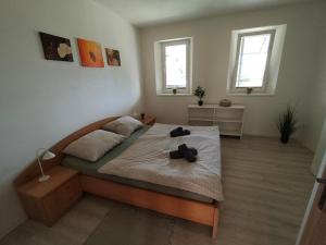 a bedroom with a bed with two shoes on it at Za hrází Poděbrady in Poděbrady