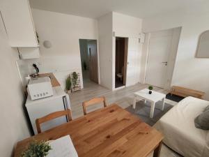 a small living room with a table and a kitchen at Za hrází Poděbrady in Poděbrady
