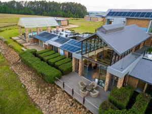 an aerial view of a house with solar panels at Vetho Farmhouse Dullstroom in Dullstroom