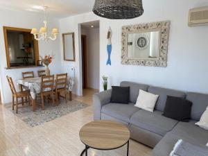 a living room with a couch and a table at Magic World Frontal 1ª línea in Oropesa del Mar