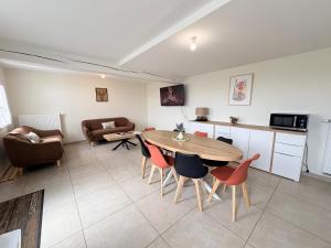 a living room with a table and chairs at Le Cerf in Montmacq