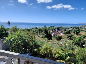 a view of the ocean from the balcony of a house at Résidence Al-amine in Koungou