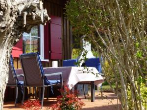 a table and chairs sitting outside of a house at Ferienhaus Jabel 24 in Jabel