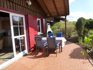 a table and chairs on the patio of a house at Ferienhaus Jabel 24 in Jabel