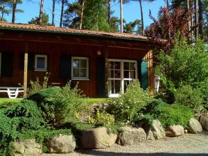 a small house with bushes in front of it at Ferienhaus Jabel 25 in Jabel