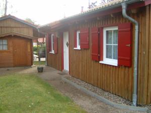 a row of houses with red doors and a window at Ferienhaus Jabel 26 in Jabel +6 photos