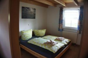a bedroom with a bed with towels on it at Ferienhaus Jabel 29 in Jabel +7 photos