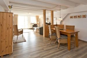 a dining room and living room with a table and chairs at Kietzspeicher App 06 in Waren
