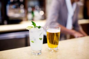 a drink and a glass of beer on a table at Hyatt Place Waco/Downtown in Waco
