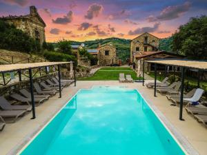 an outdoor swimming pool with chairs and a house at Le Querce Farmhouse in Agropoli
