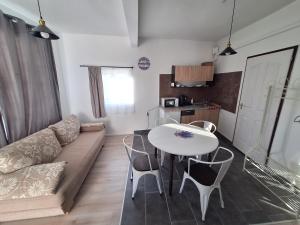 a living room with a couch and a table and chairs at Levendula Porta in Balatonfůzfő
