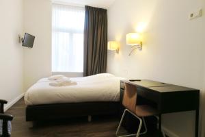 Postel nebo postele na pokoji v ubytování Hotel Carillon