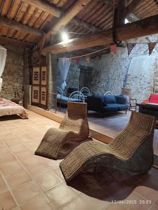 a living room with two chairs and a couch at Aux Mimosas in La Tour-sur-Orb