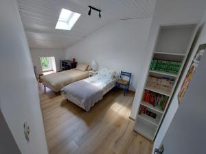 a bedroom with a bed and a book shelf at Gite des Anglais in Marnay