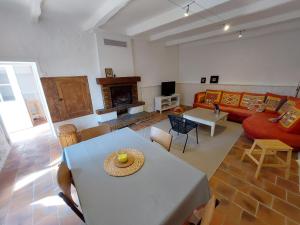 a living room with a table and a couch at Gite des Anglais in Marnay