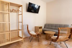 a living room with a couch and chairs at Krępianka in Sandomierz