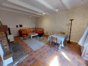 a living room with a table and a couch at Gite des Anglais in Marnay