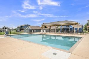 a swimming pool in front of a house at Bridges Bay Vacation Cabin 185 in Arnolds Park