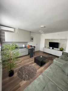 a living room with a couch and a table at Center apartment in Gnjilane