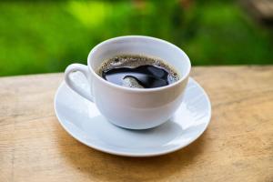 a cup of coffee on a plate on a table at Retazos Eco Hotel in Iquitos +26 photos