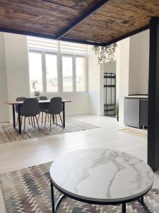 a living room with a table and chairs at ETALON in the heart of Novi Sad in Novi Sad