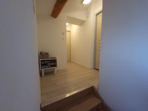 an empty room with a staircase and a room with white walls at Au 3 bis in Caderousse