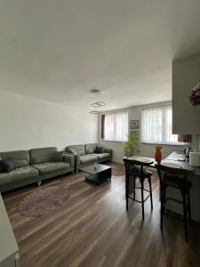 a living room with a couch and a table at Center apartment in Gnjilane