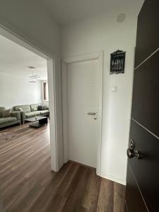 an empty living room with a door and a couch at Center apartment in Gnjilane