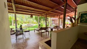 a patio with a table and chairs and a view of a yard at Villa Jennifer in Tingo María