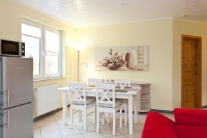 a kitchen and dining room with a white table and chairs at FH Wendorff in Klink +20 photos