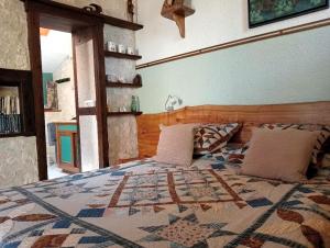 a bedroom with a bed with a quilt on it at Ferme de Laspeyrières in Montcuq