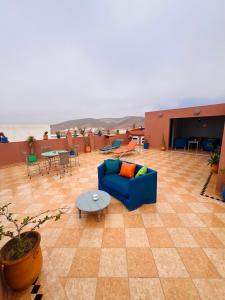 a living room with a blue couch and a table at Zakar Apartments & Terrace in Mirleft